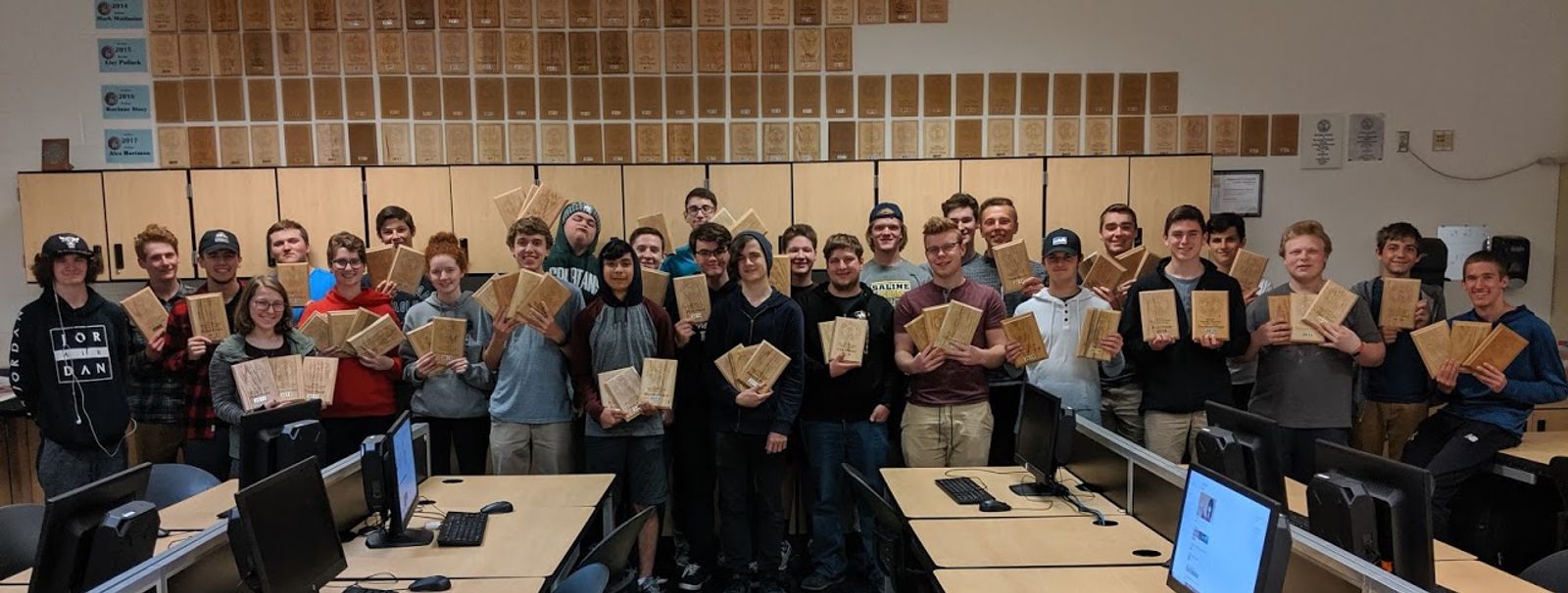 Students showing off their awards from a STEM competition