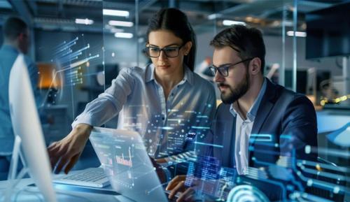 Stock image showing two coworkers in a tech environment.