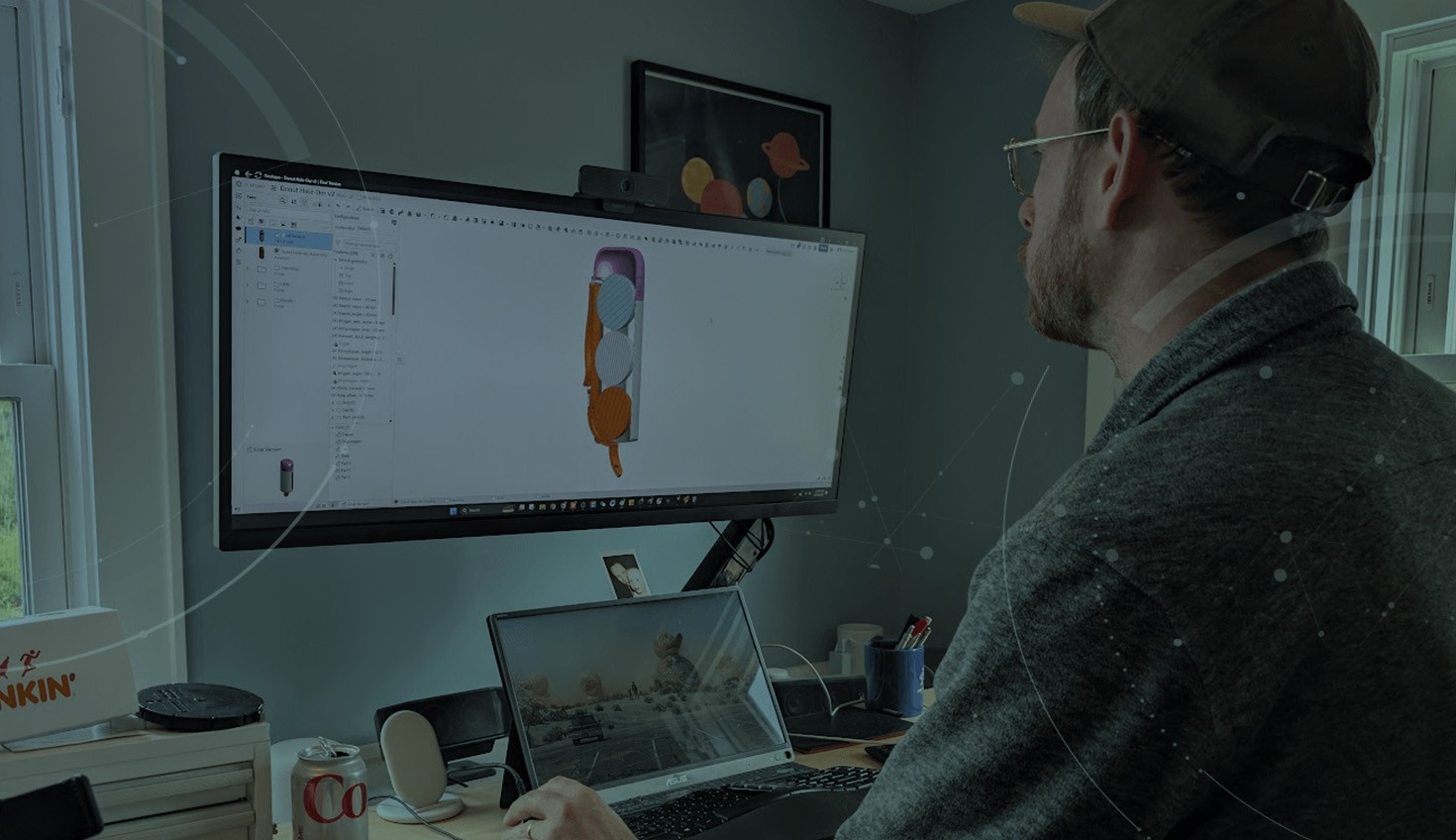 Image darkened with an overlay of informal's Sam Holland using Onshape to design a donut hole-der.