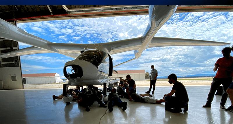 people looking at BETA aircraft in hanger