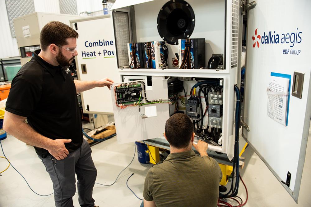 two Dalkia workers inspecting machine