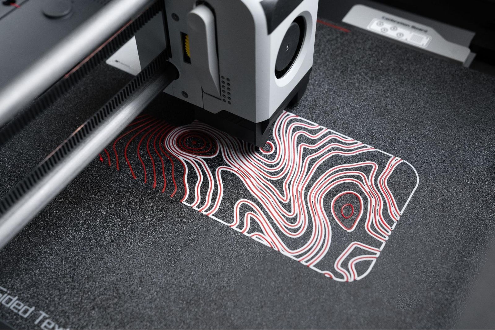 A 3D printer developed by Red Wolf Technology printing a custom phone case design.
