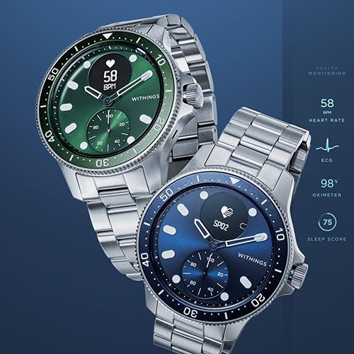 two watches are sitting next to each other on a blue background .