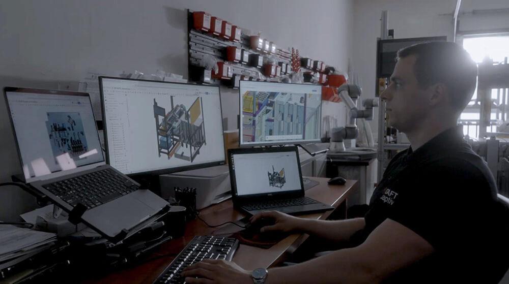 nDraft engineer at a workstation working in Onshape