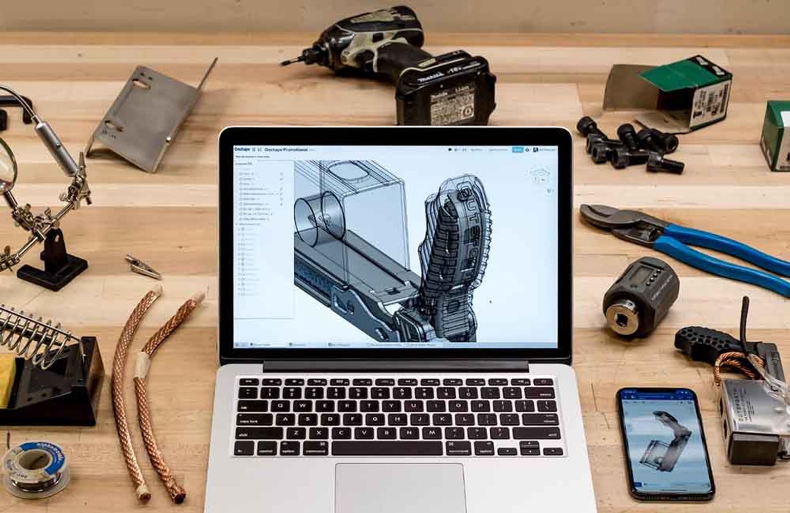 laptop surrounded by tools.