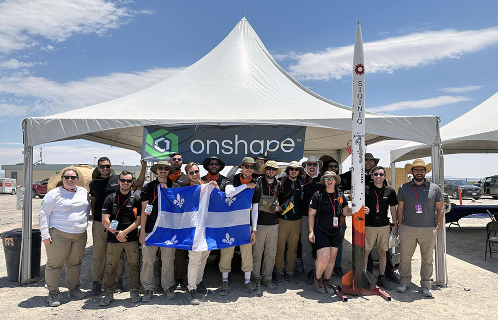 competitors stand by an Onshape sign