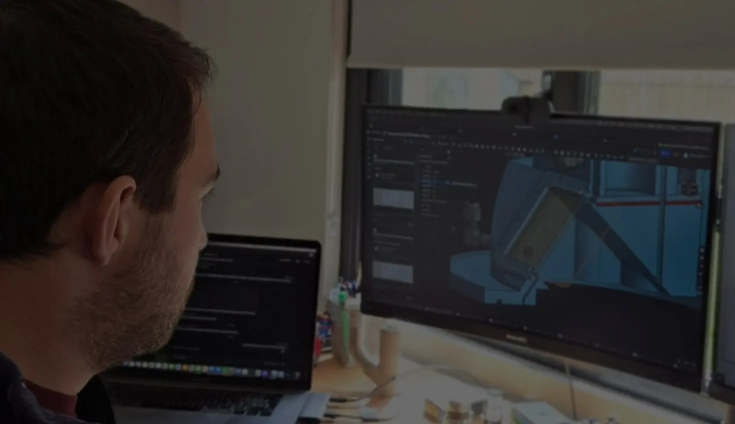 An engineer looks at a CAD drawing on a computer screen.