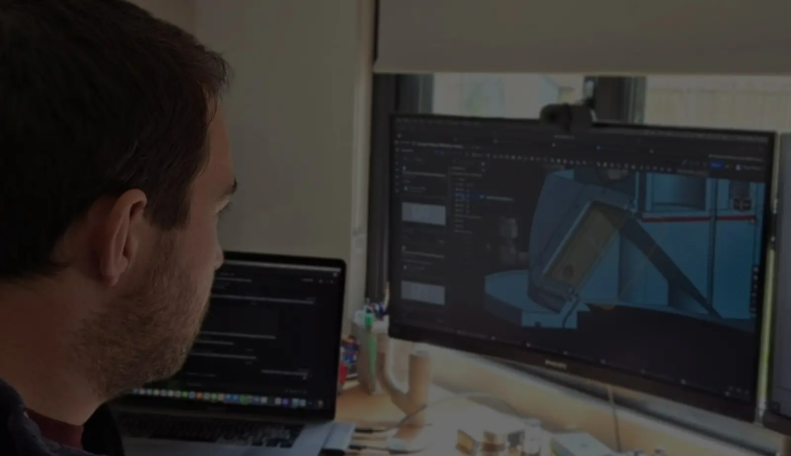 An engineer looks at a CAD drawing on a computer screen. 