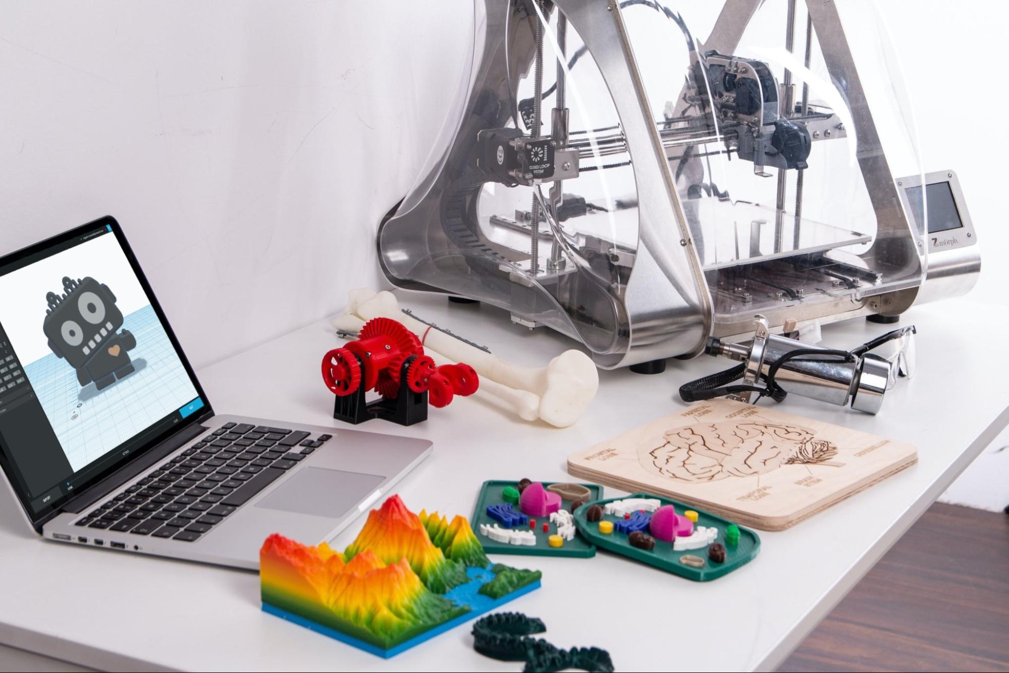 A desk with a 3D printer and 3D printed objects