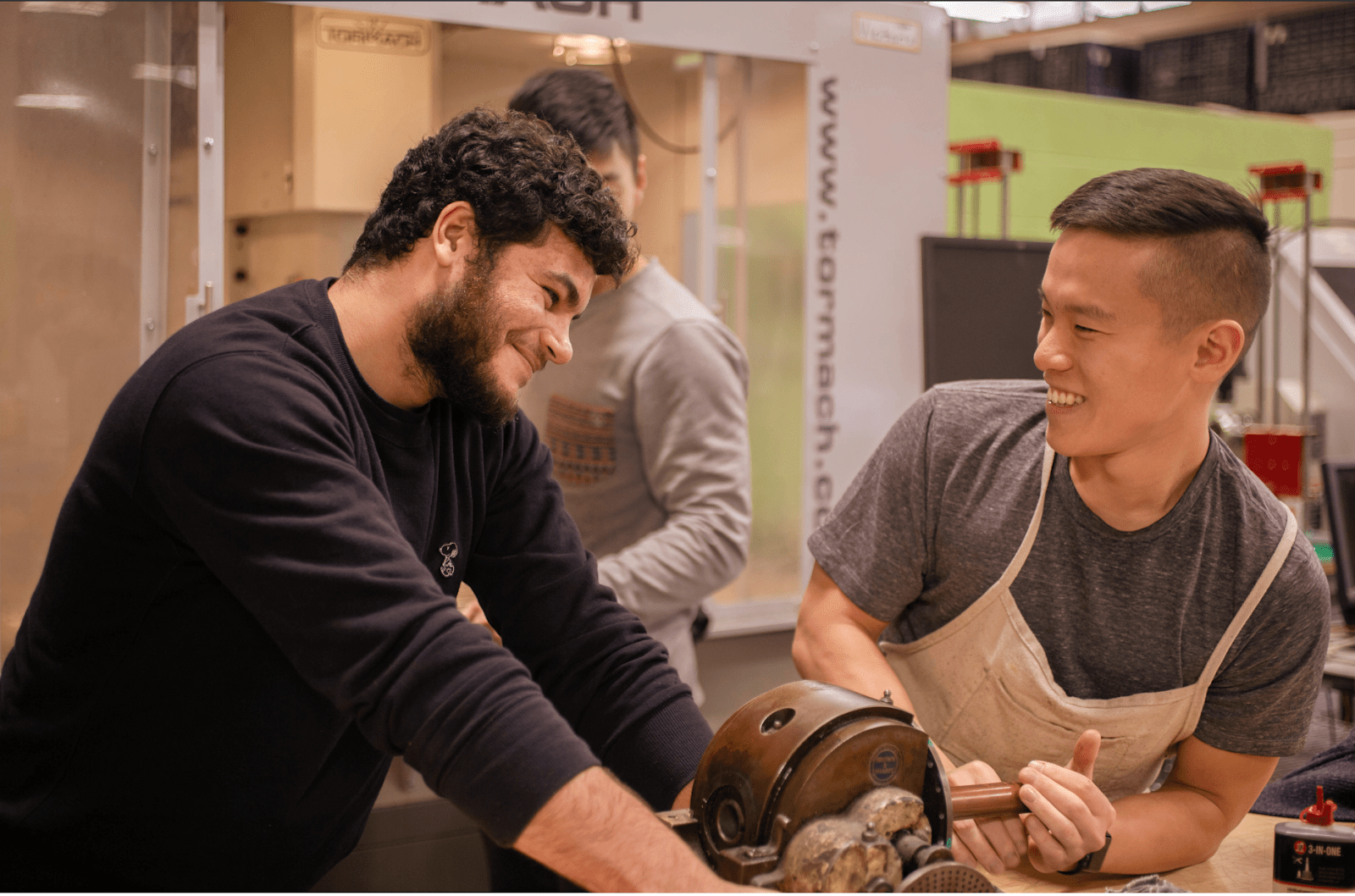 Photo of Koi Prosthetics co-founders Luke Morales and Matthew Lo machining usable prosthetic socket prototypes at the Brown University Design Workshop.